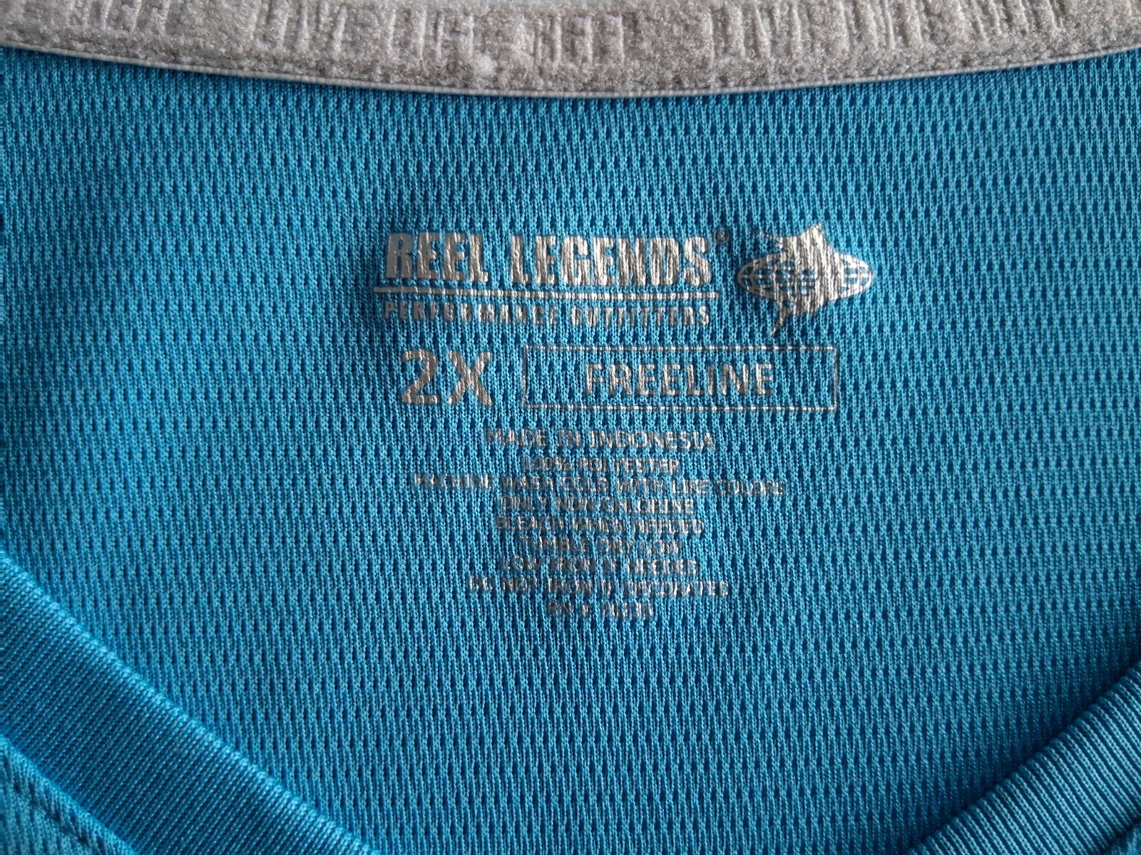 Reel Legends size 2X Aqua blue v-neck performance shirt. Excellent condition