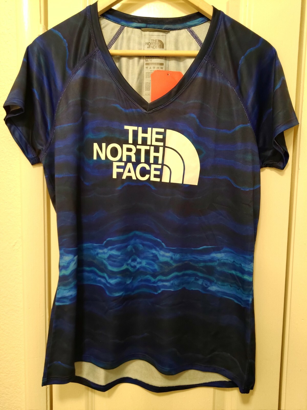 North Face Women’s Short Sleeve Graphic Reaxion V Neck T Shirt Aztec Blue Large