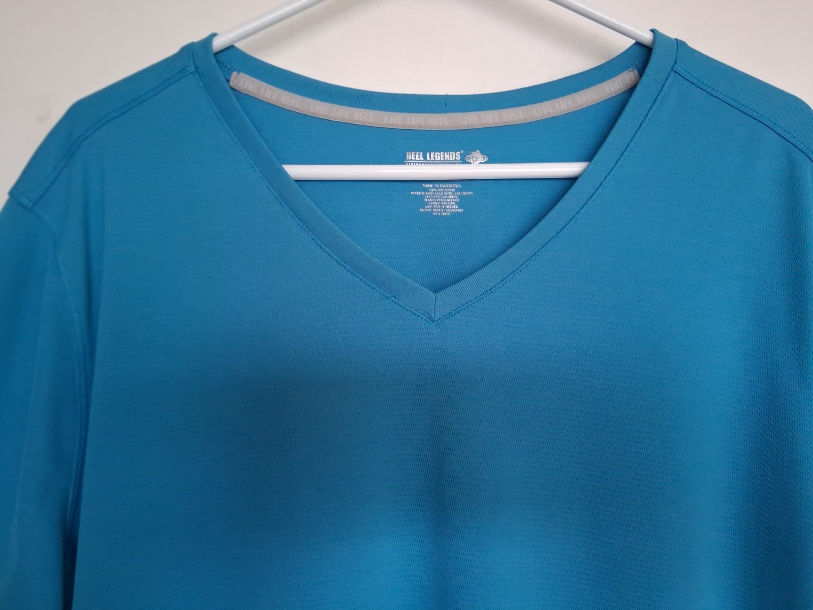 Reel Legends size 2X Aqua blue v-neck performance shirt. Excellent condition