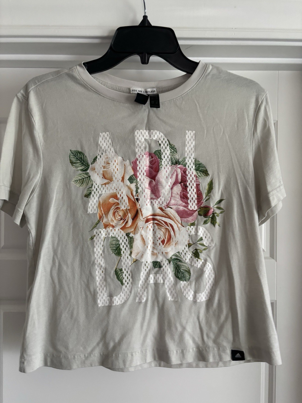 Adidas Cream Colored Shirt With Adidas Spelled Out On The Front And Flowers