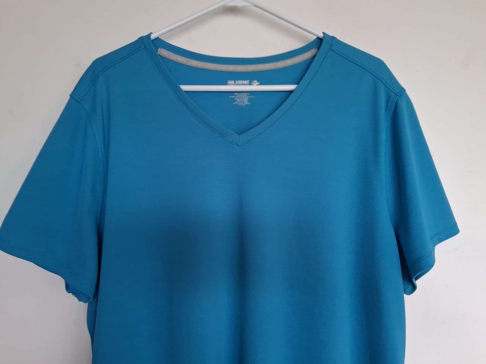Reel Legends size 2X Aqua blue v-neck performance shirt. Excellent condition