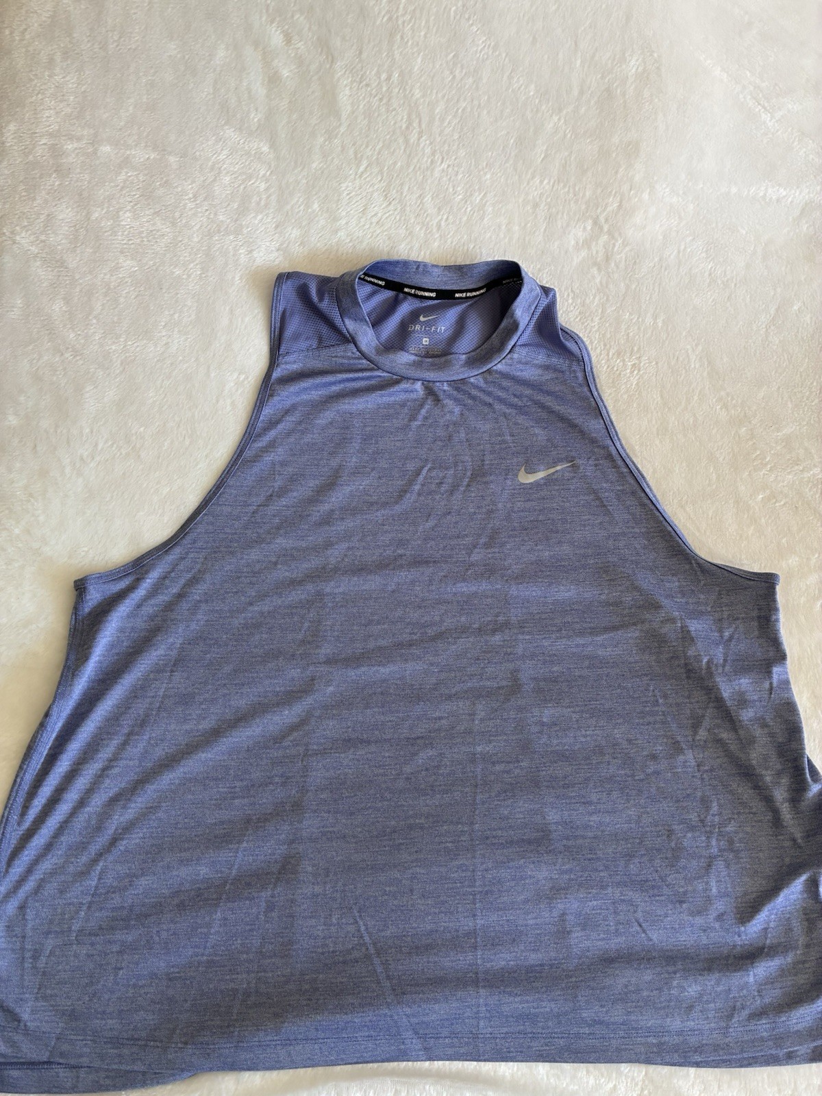 Nike sleeveless training tank in heather blue. Dri-FIT fabric wicks moisture