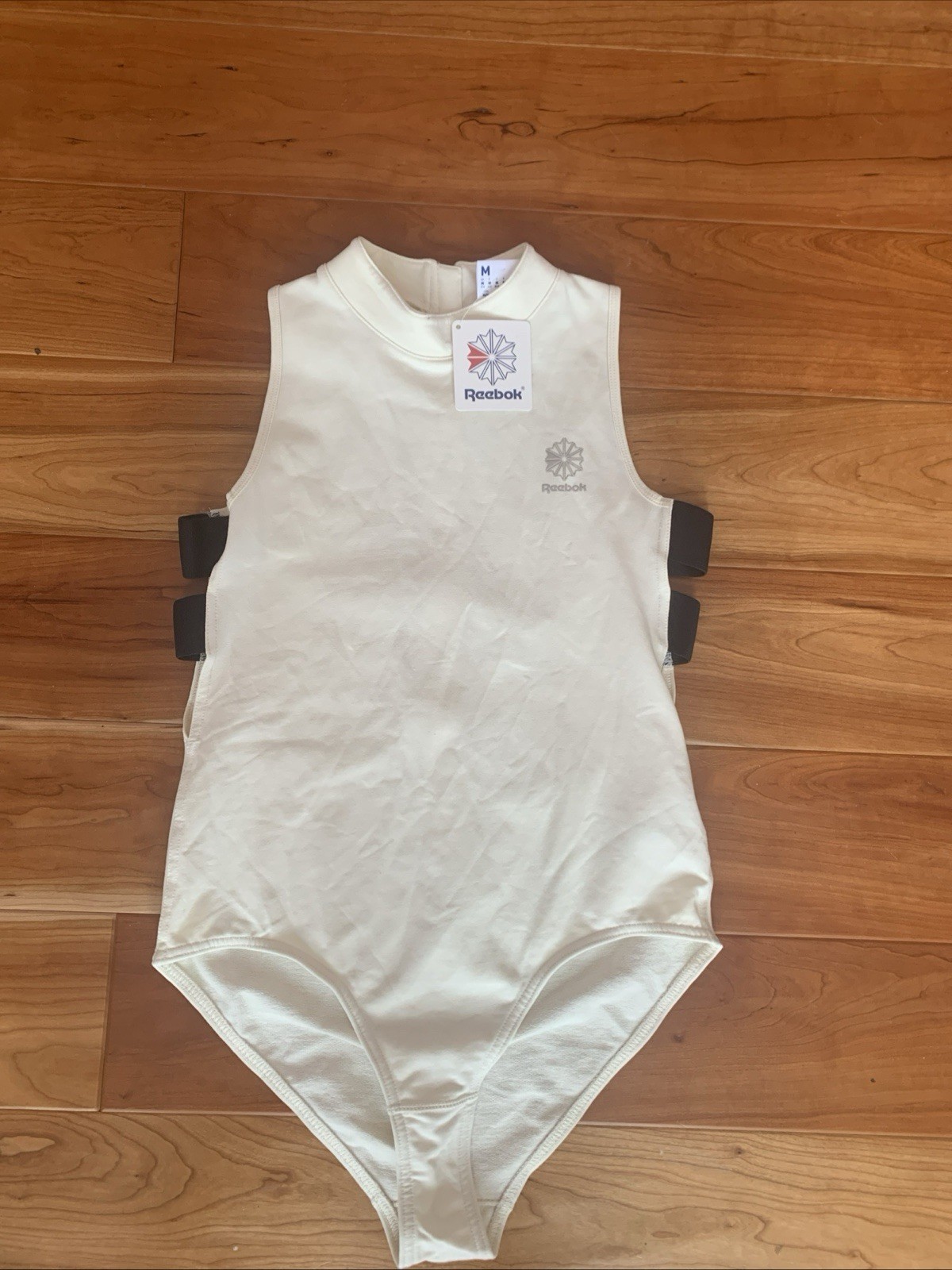 NWT Reebok Classic Womens Size Medium DC Bodysuit Cream With Black Accents